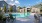 a swimming pool with chairs around it