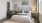 a bedroom with a bed and a mirror
