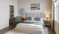 a bedroom with a bed and a mirror